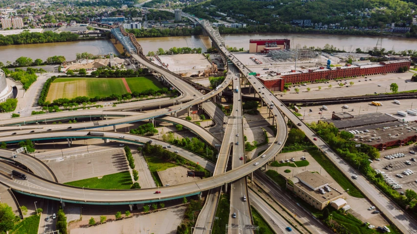 an aerial view of a highway intersection in a city, by Brad Holland, pittsburgh, soaring towers and bridges, promo image, stacked image