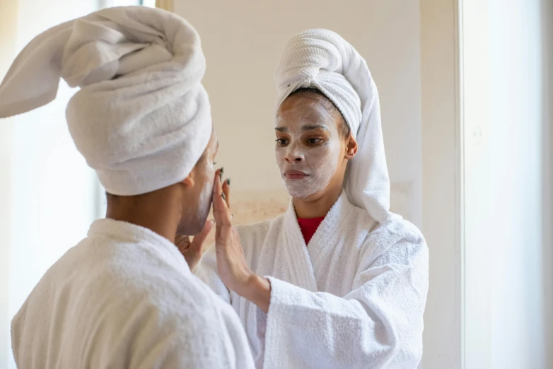 a couple of people that are standing in front of a mirror, wearing a towel, facial, white facepaint, tan complexion