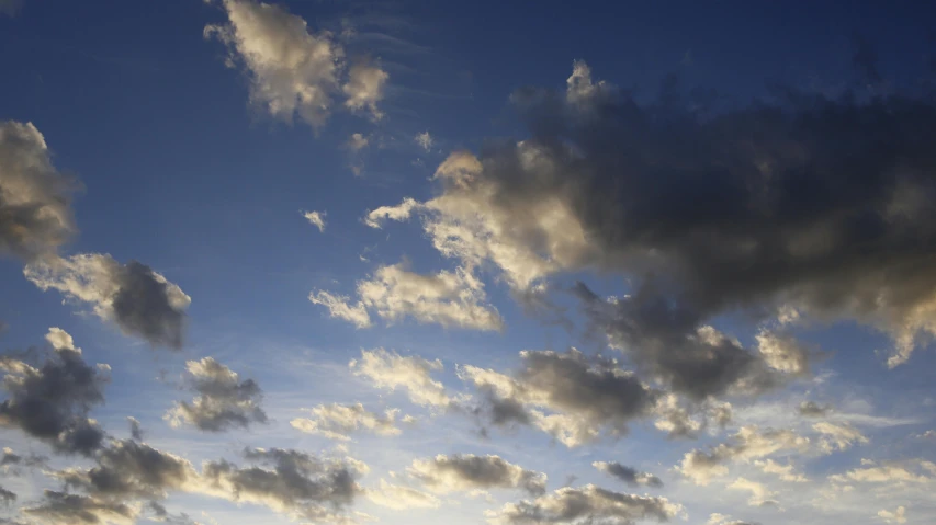 a man flying a kite on top of a lush green field, by David Simpson, unsplash, minimalism, layered stratocumulus clouds, blue sunset, close - up photograph, today\'s featured photograph 4k