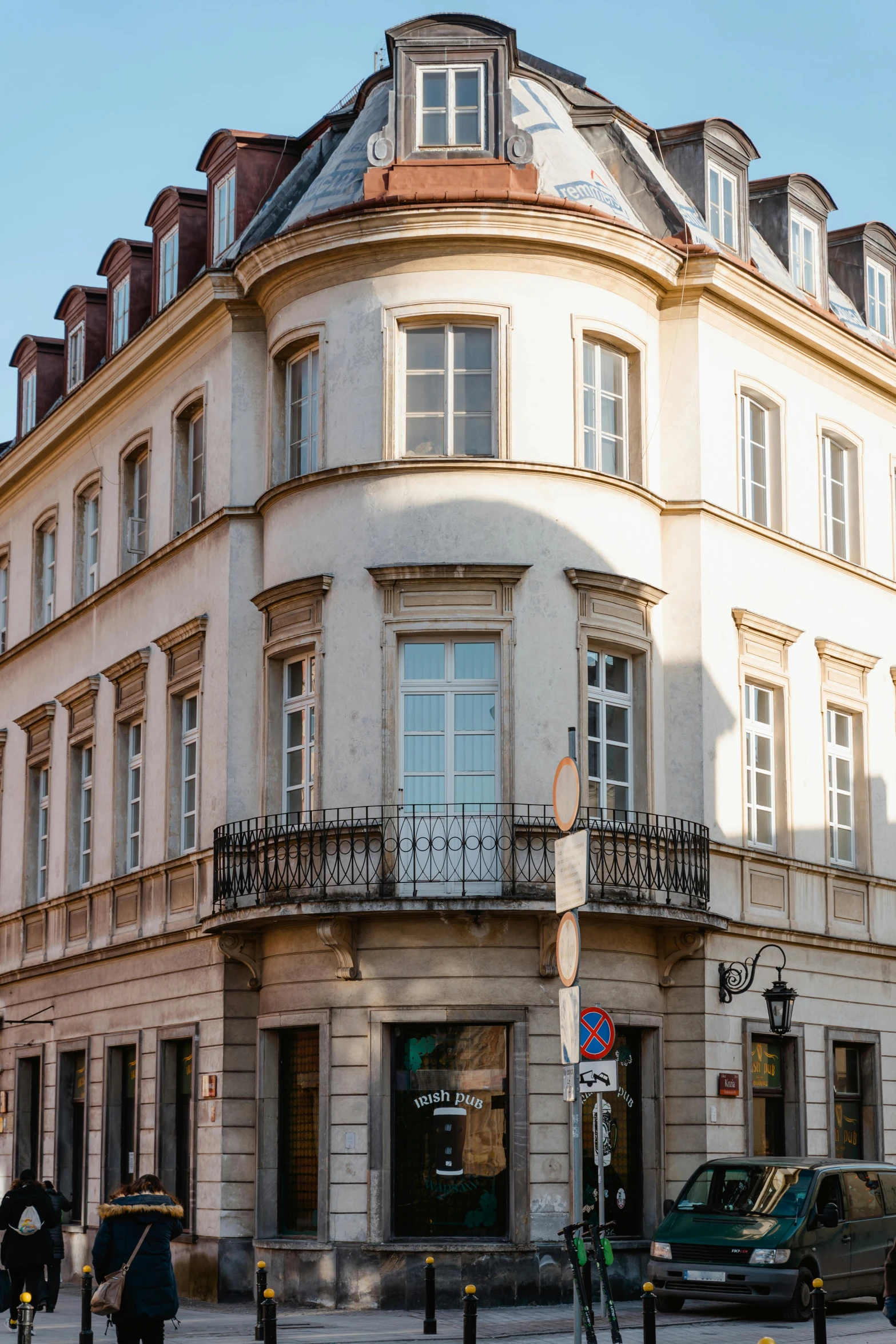 a large white building sitting on the side of a street, inspired by Albert Paris Gütersloh, streets of heidelberg, exterior shot, gold, lots de details