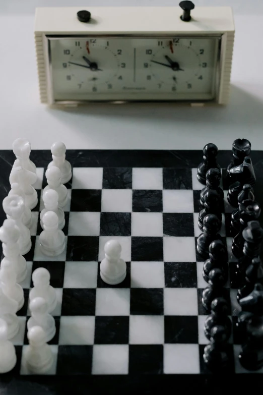 a close up of a chess board with a clock in the background, a marble sculpture, unsplash, hyperrealism, still frame from a movie, shot from above, looking at each other mindlessly, live-action archival footage