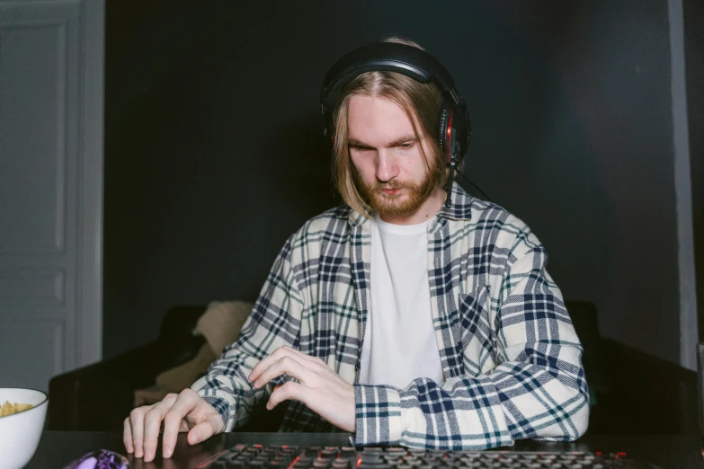 a man sitting at a table with a keyboard and mouse, an album cover, inspired by Niko Henrichon, pexels, pewdiepie, turntablism dj scratching, large portrait, gaming