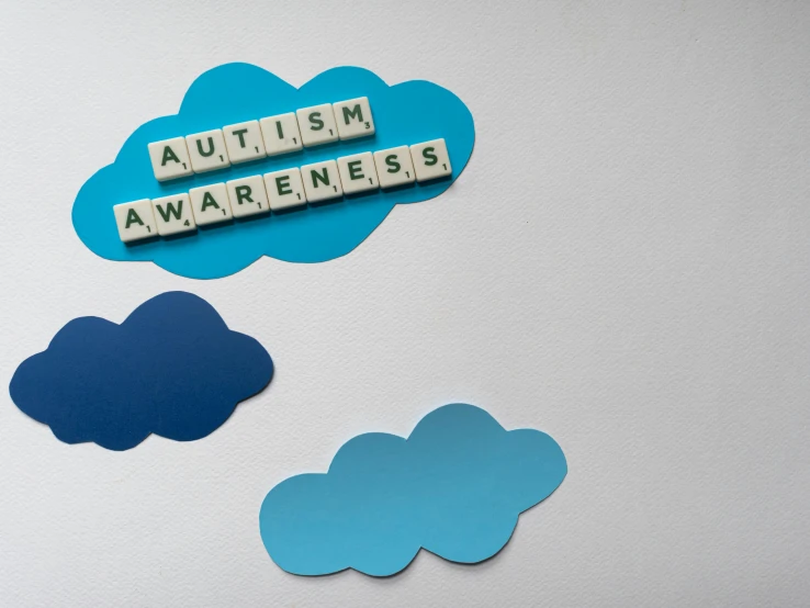 scrabbles spelling autism awareness on a refrigerator, a jigsaw puzzle, trending on pexels, graffiti, atmospheric clouds', awards, clouds, whiteboards