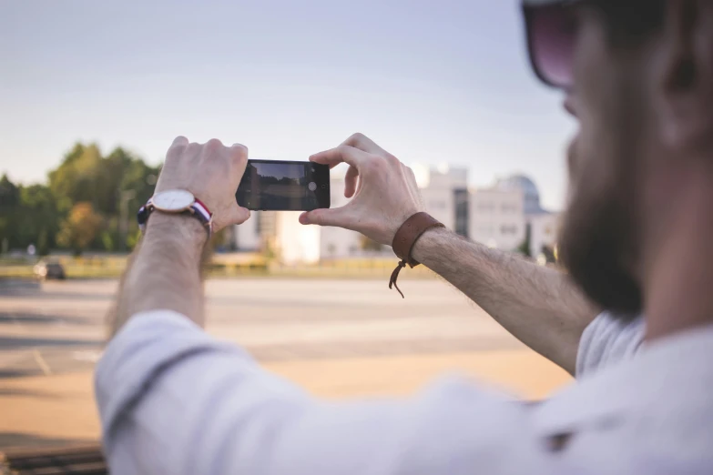 a man taking a picture with his cell phone, a picture, by Niko Henrichon, pexels contest winner, mobile still frame. 4k uhd, ultrawide lens”, half image, rectangle