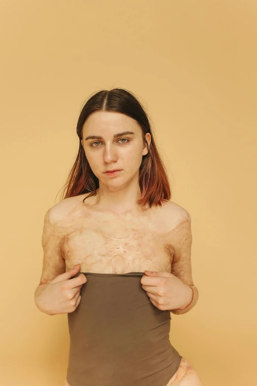 a woman in a bodysuit posing for a picture, an album cover, inspired by Ren Hang, trending on pexels, hyperrealism, flawless epidermis, furr covering her chest, deteriorated, handsome girl