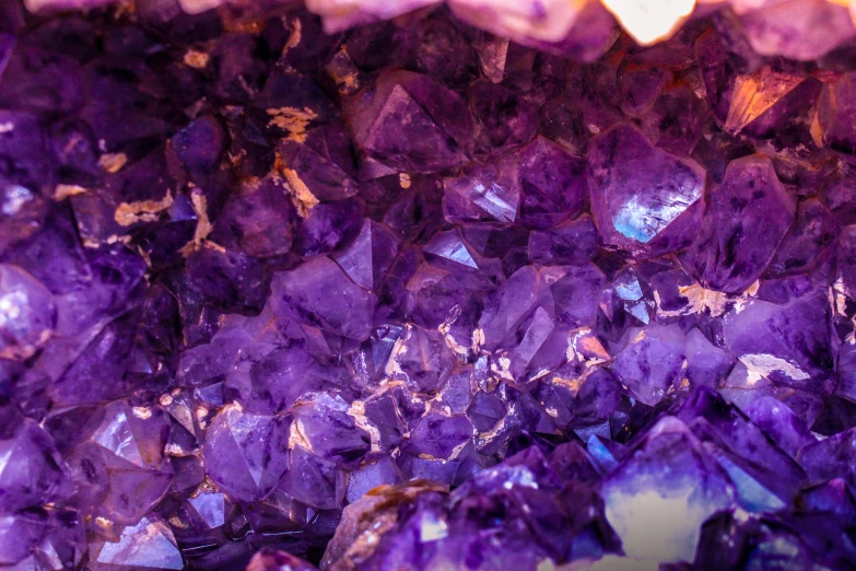 a pile of purple crystals sitting on top of a table, by Adam Marczyński, pexels, 🦩🪐🐞👩🏻🦳, inside a cavernous stomach, beautiful features, second colours - purple