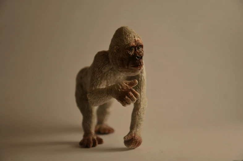 a close up of a toy monkey on a white surface, a statue, inspired by Alex Petruk APe, unsplash, photorealism, crawling humanoid monsters, 1 / 8 0 s, made from million point clouds, jack baker from resident evil 7