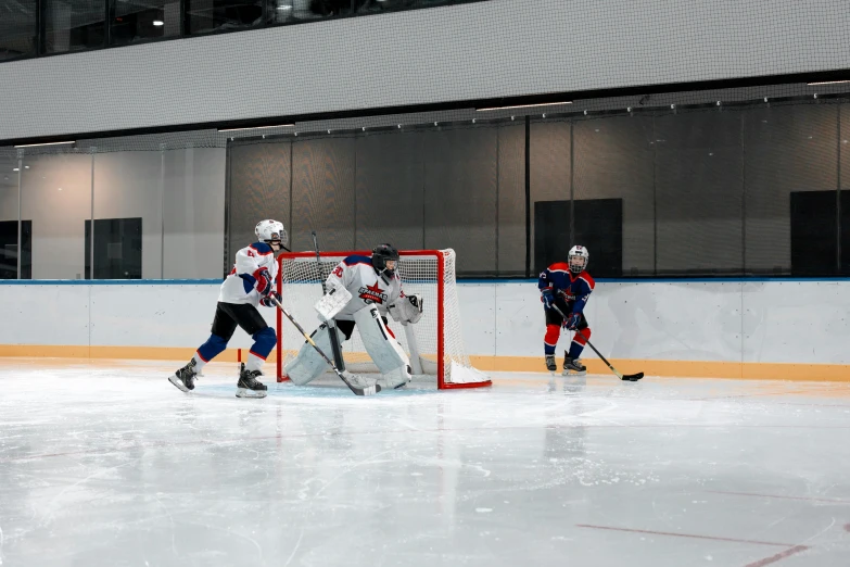 a group of young men playing a game of hockey, pexels contest winner, full ice hockey goalie gear, modern minimalist f 2 0, shiny silver, a wide shot