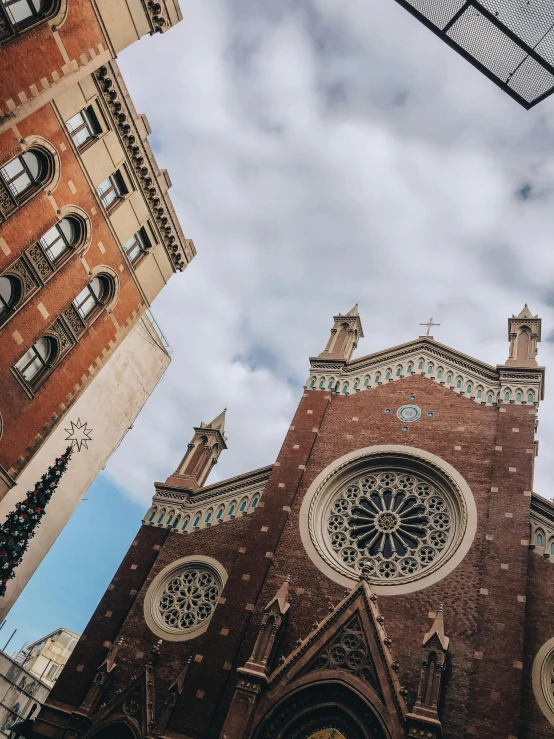 a church with a clock on the front of it, unsplash contest winner, epic buildings in the center, looking up at the camera, buenos aires, low quality photo