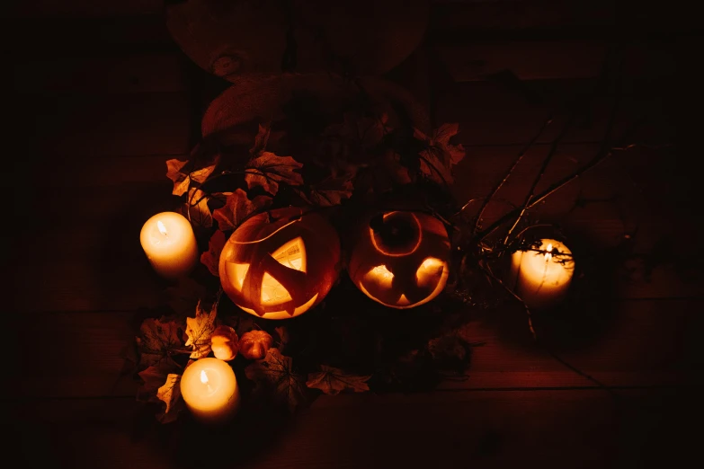 a group of pumpkins sitting on top of a wooden table, by Carey Morris, pexels contest winner, vanitas, candlelit, avatar image, ☁🌪🌙👩🏾, glowing ceremonial markings