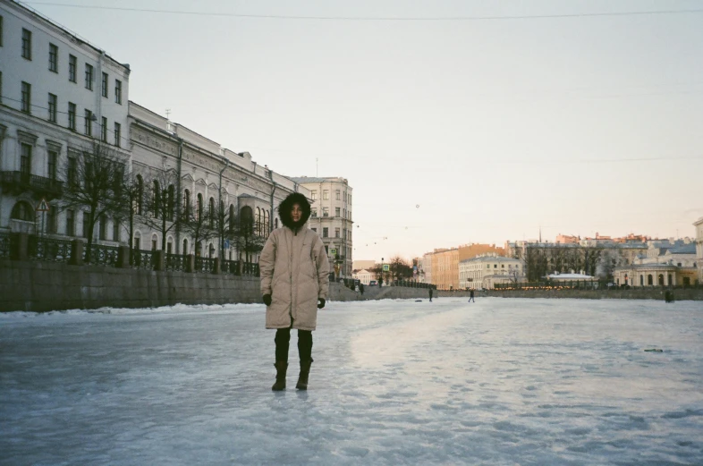 a person standing in the snow on a skateboard, inspired by Illarion Pryanishnikov, pexels contest winner, visual art, kodak portra 400 film, beautiful city black woman only, in an icy river, on a great neoclassical square