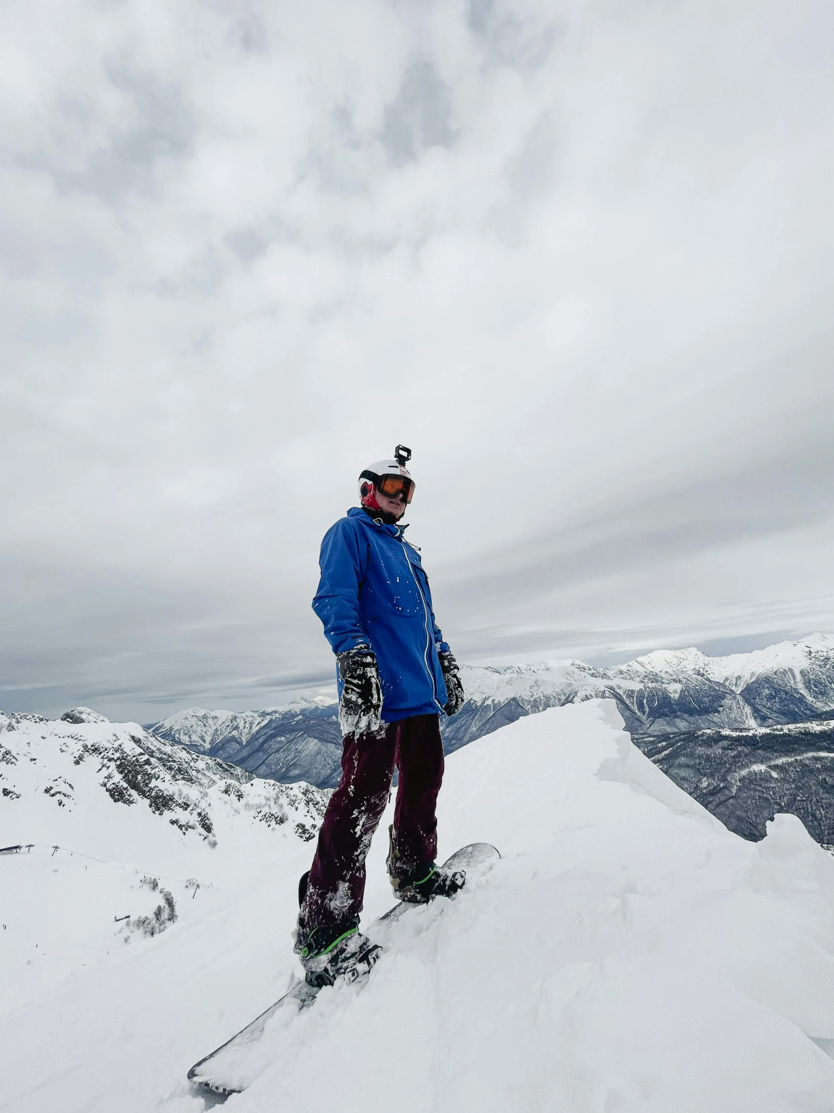 a man standing on top of a snow covered mountain, holding a snowboard, photo taken in 2018, profile image, helmet off