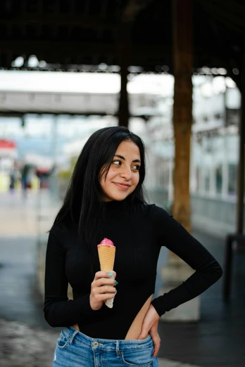 a beautiful young woman holding an ice cream cone, by Julia Pishtar, pexels contest winner, with straight black hair, wearing black clothes, ameera al-taweel, pink