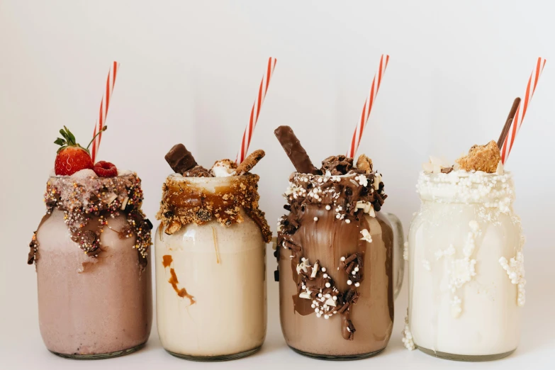 a row of milkshakes sitting next to each other, trending on pexels, red brown and white color scheme, with a bunch of stuff, profile image, melbourne