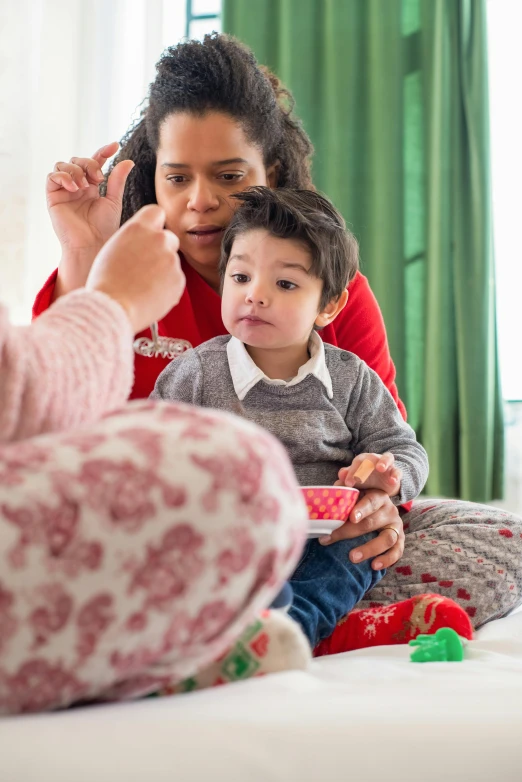 a woman combing a child's hair while sitting on a bed, wearing festive clothing, slide show, brushes her teeth, varying ethnicities