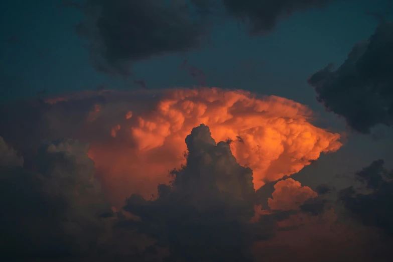 a couple of clouds that are in the sky, by Neil Blevins, pexels contest winner, orange and red lighting, evening storm, mushroom cloud, cotton candy clouds