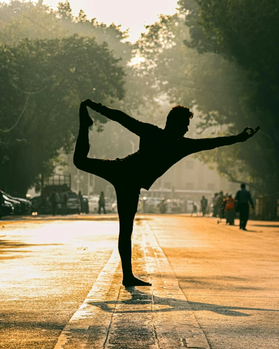 a man doing a yoga pose in the middle of the street, a statue, pexels contest winner, arabesque, lgbtq, instagram story, warmly lit, heroic shooting bow pose