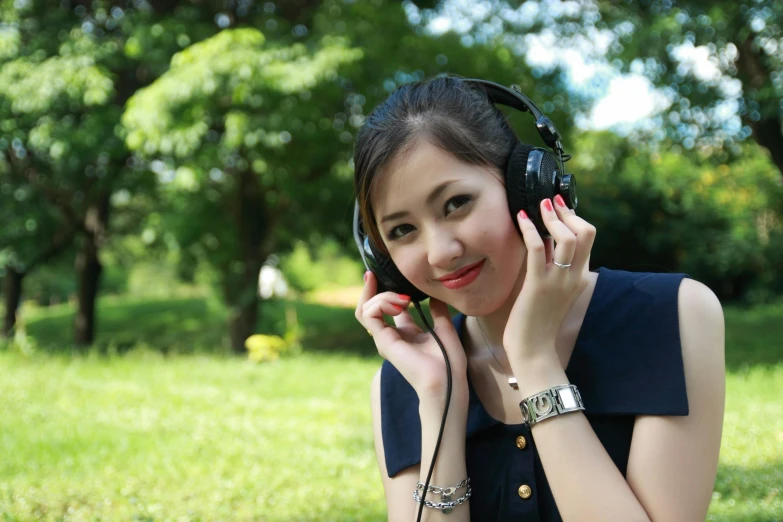 a woman holding a pair of headphones to her ear, an album cover, pixabay, in the park, avatar image, asian, 15081959 21121991 01012000 4k