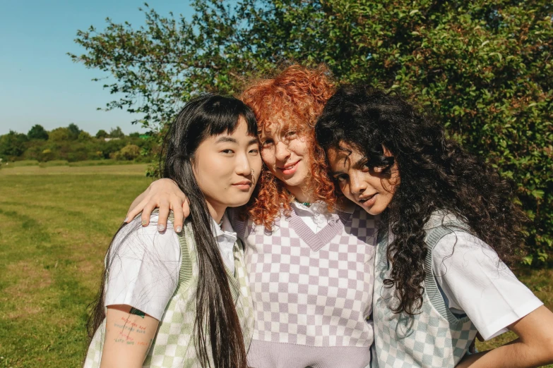 three women standing next to each other in a field, trending on pexels, renaissance, purple checkerboard, wearing a school uniform, curly bangs, outlive streetwear collection