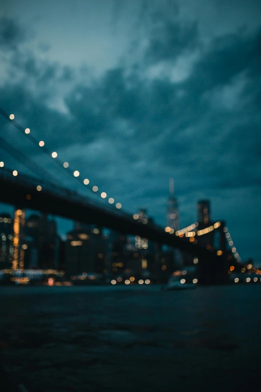 a view of the brooklyn bridge at night, unsplash contest winner, overcast bokeh - c 5, teal aesthetic, stormy night, city