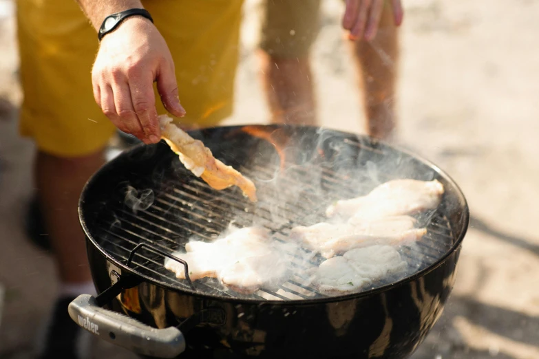 a close up of a person cooking food on a grill, lachlan bailey, yellow, gushy gills and blush, chicken