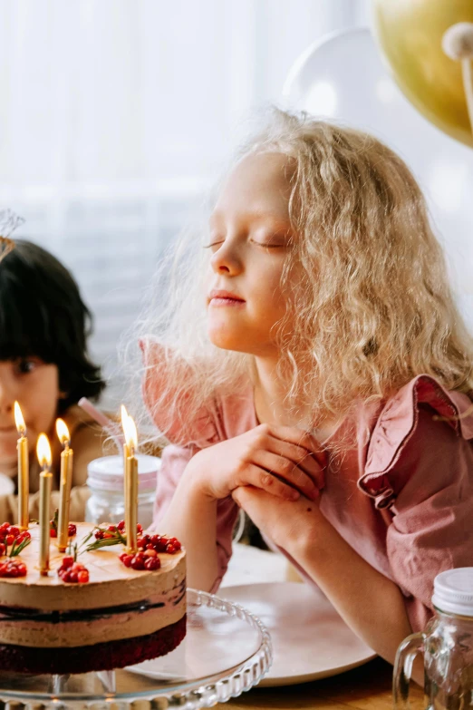 a little girl blowing out candles on a birthday cake, an album cover, pexels, renaissance, two girls, a blond, delicate soft hazy lighting, gif