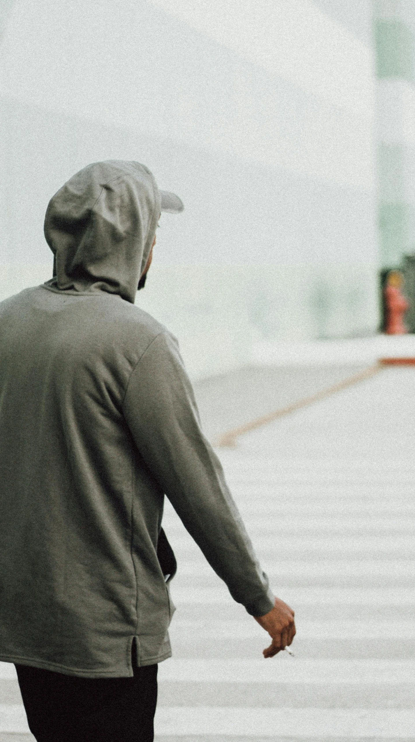 a man riding a skateboard across a cross walk, a picture, unsplash, realism, gray hoodie, facing away, low quality photo, background image