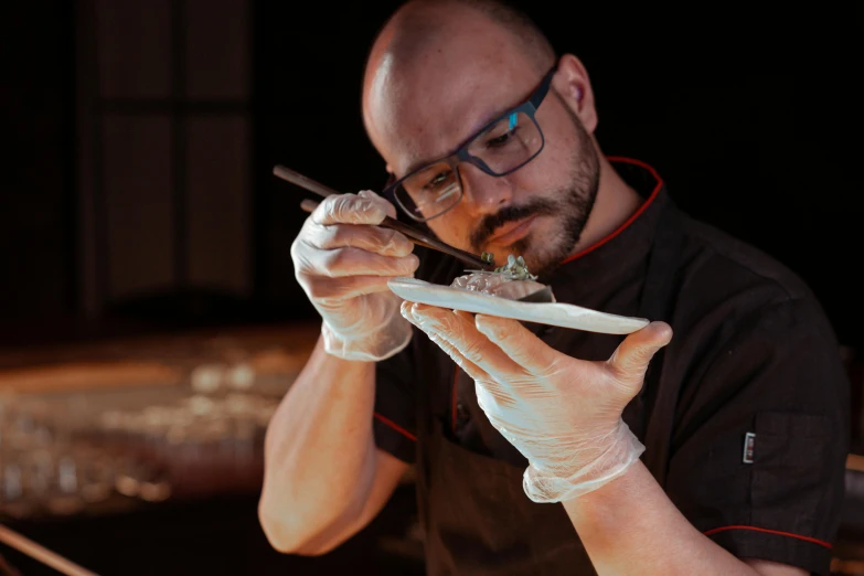 a close up of a person holding a plate of food, inspired by Kanō Naizen, pexels contest winner, fantastic realism, wearing lab coat and glasses, professional gunsmithing, carving, avatar image