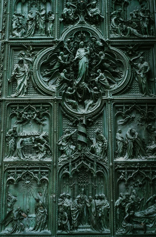 a close up of a statue on the side of a building, an album cover, by Luca della Robbia, gothic art, iron gate door texture, green and black color scheme, spiritual scene, gates of hell