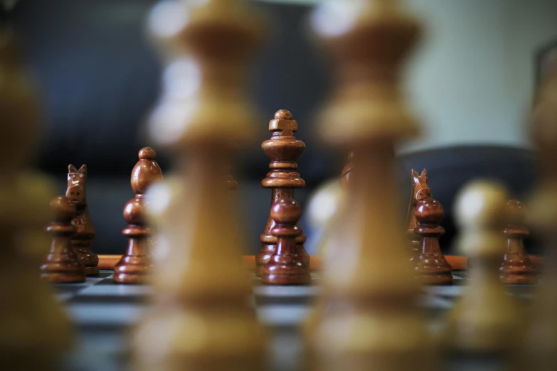 a group of chess pieces sitting on top of a chess board, a picture, by Carey Morris, unsplash, fan favorite, portrait mode photo, thumbnail, a wooden