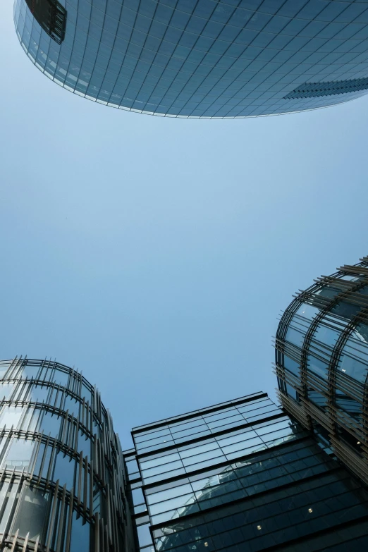 some very tall buildings in a big city, inspired by Zaha Hadid, flickr, blue sky above, circular towers, sky bridge, today\'s featured photograph 4k