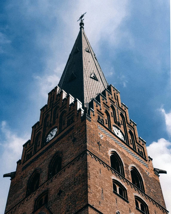 a tall brick tower with a clock at the top, by Christen Dalsgaard, pexels contest winner, lead - covered spire, thumbnail, low quality grainy, exterior photo