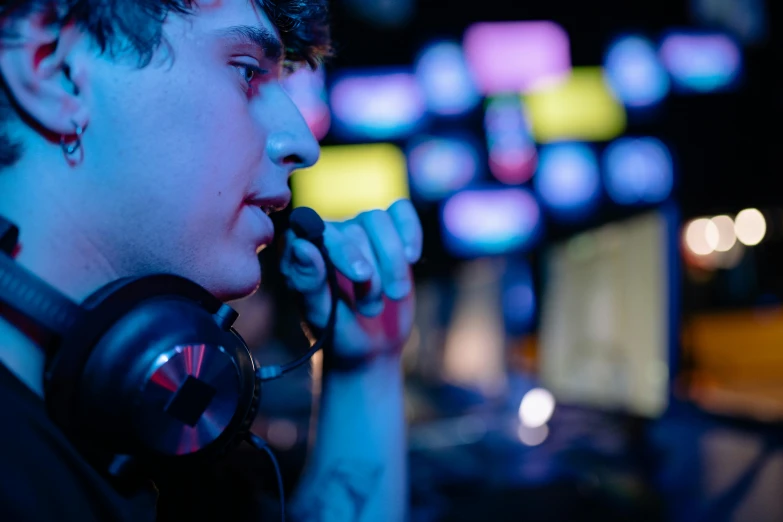 a man with headphones on talking on a cell phone, featured on reddit, realism, esports, shroud, in a nightclub, profile image