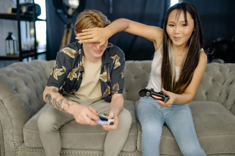 a couple of people that are sitting on a couch, trending on pexels, realism, playing games, an asian woman, from valve, avatar image