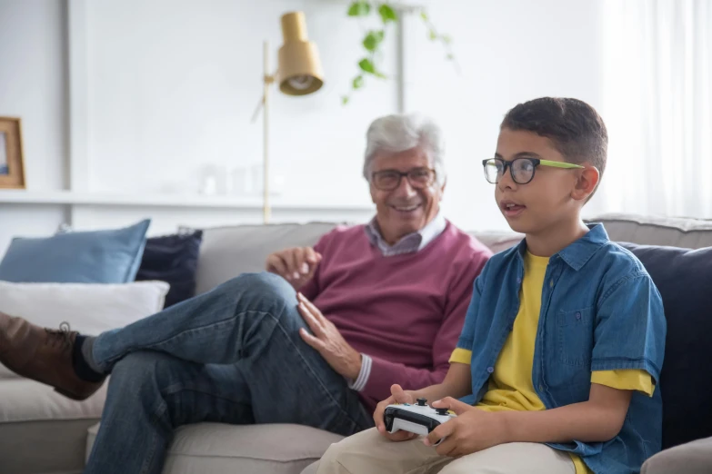 a young boy sitting on top of a couch next to an older man, pexels contest winner, incoherents, video game control, blippi, tv still, avatar image