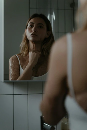 a woman standing in front of a bathroom mirror, inspired by Elsa Bleda, trending on pexels, renaissance, rotting clay skin, scales covering her chest, blonde swedish woman, silicone skin