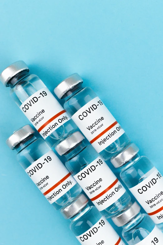 several vials of covidd vaccine on a blue background, thumbnail, featured, profile pic, 1x