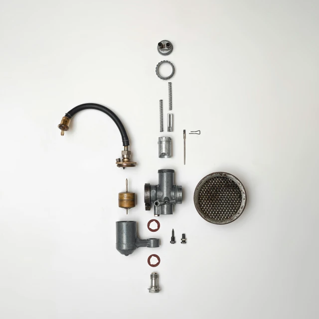 a close up of a sink faucet on a white surface, by Ben Zoeller, assemblage, exploded parts assembly, grey, high quality image, deconstructed waffle