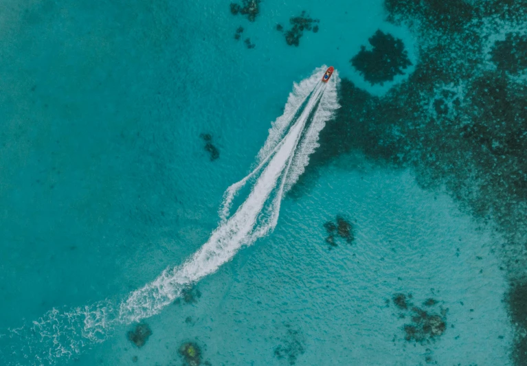 a jet ski in the middle of a body of water, a screenshot, pexels contest winner, great barrier reef, sharp detail, unsplash photo contest winner, bird\'s eye view