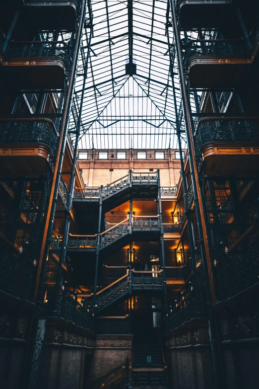 the inside of a building with a glass roof, inspired by Elsa Bleda, unsplash contest winner, a steampunk store, highrise made up staircases, black steel buildings, inspect in inventory image