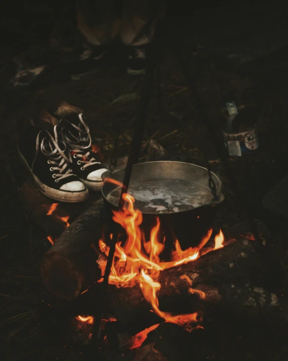 a pair of shoes sitting on top of a fire, pexels contest winner, cooking it up, camp half-blood, vintage aesthetic, profile image