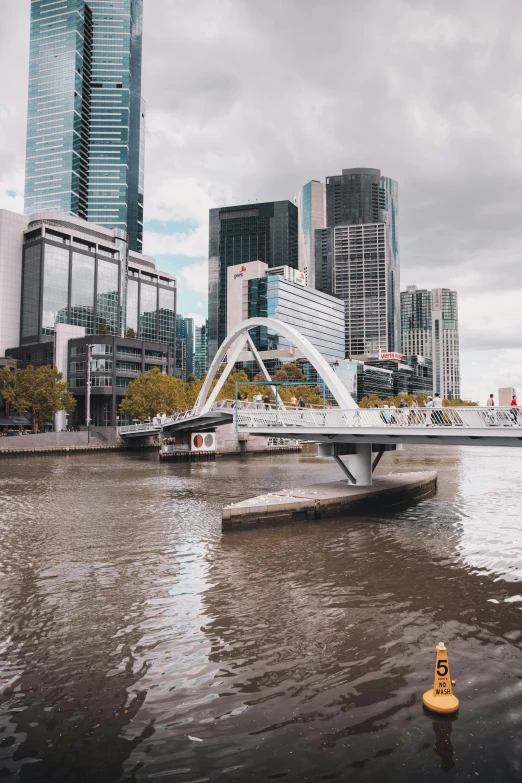 a yellow fire hydrant sitting in the middle of a river, inspired by Zaha Hadid, happening, melbourne, all buildings on bridge, low quality photo, square