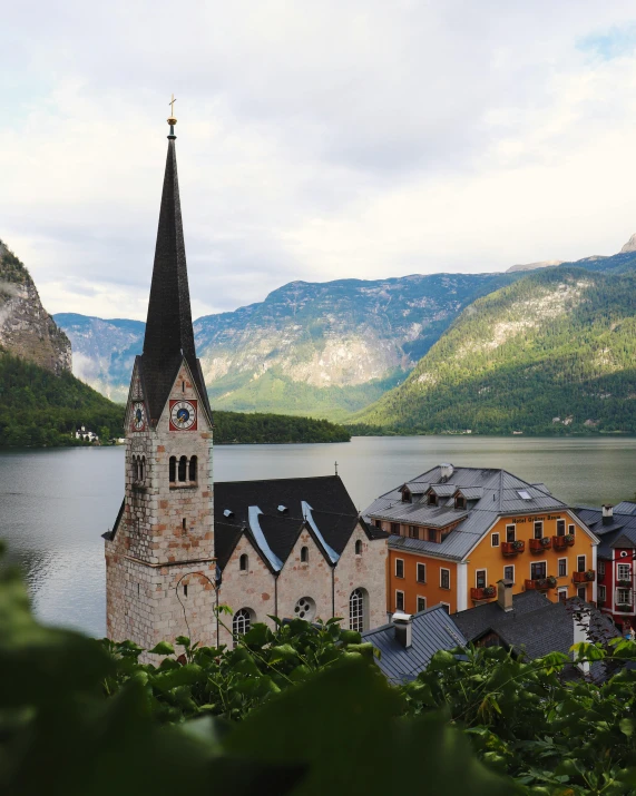 a church sitting on top of a lush green hillside, by Julia Pishtar, mountains and lakes, european buildings, ornately dressed, beautifully lit