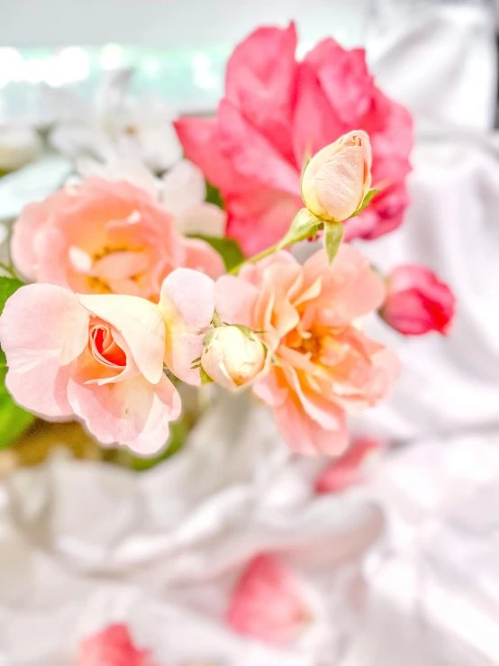 a close up of flowers in a vase on a bed, by Robbie Trevino, trending on unsplash, made of silk paper, 🎀 🧟 🍓 🧚, detail shots, delicate garden on paper