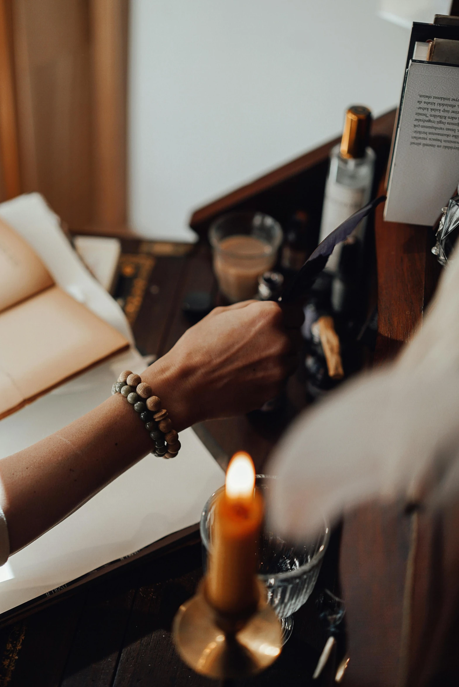 a woman reading a book next to a candle, by Jan Tengnagel, trending on pexels, renaissance, leather cuffs around wrists, on the altar, charcoal and champagne, bracelets