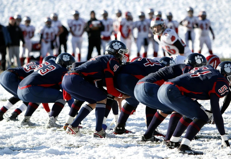a group of men standing on top of a snow covered field, football armor, 15081959 21121991 01012000 4k, navy, red and blue garments