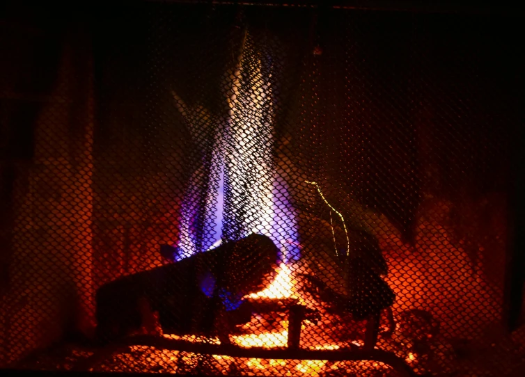 a close up of a fire in a fireplace, a digital rendering, by Carey Morris, pexels, figuration libre, cold blue light from the window, taken in the late 2010s, instagram picture, warm tri - color
