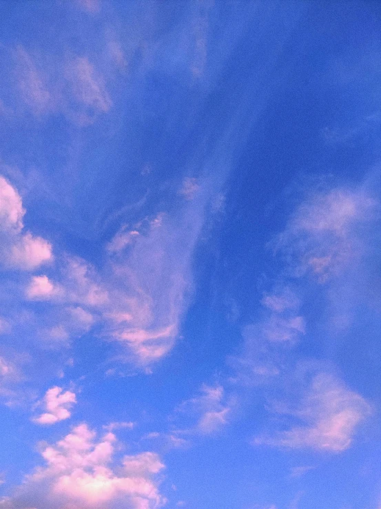 a man flying a kite on top of a lush green field, a picture, unsplash, aestheticism, fluffy pink anime clouds, ☁🌪🌙👩🏾, pastel blue, snapchat photo