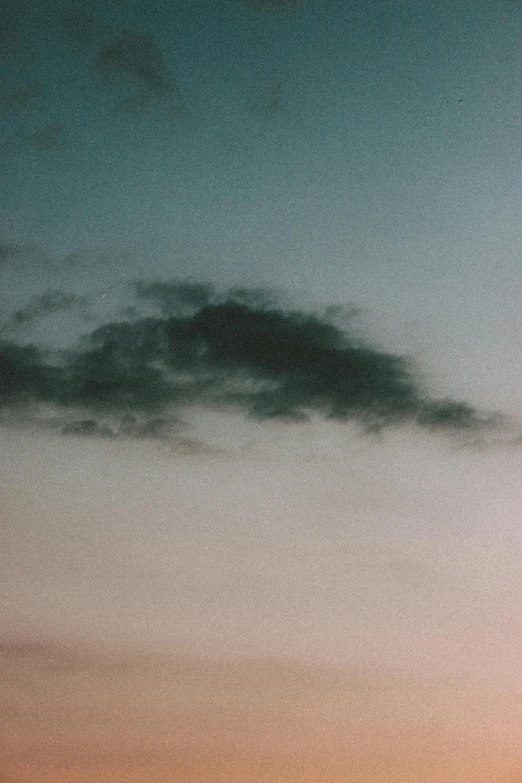 there is a plane that is flying in the sky, a polaroid photo, inspired by Elsa Bleda, unsplash, aestheticism, humid evening, altostratus clouds, photo taken on fujifilm superia, alessio albi