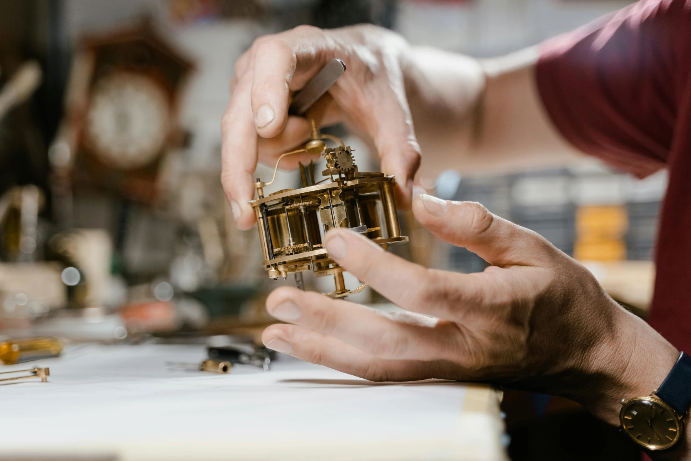 a close up of a person working on a clock, by Matthias Stom, in a workshop, instagram post, golden miniatures, an escape room in a small